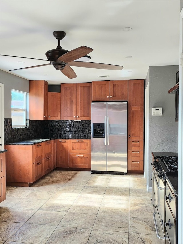 kitchen featuring decorative backsplash, ceiling fan, and appliances with stainless steel finishes