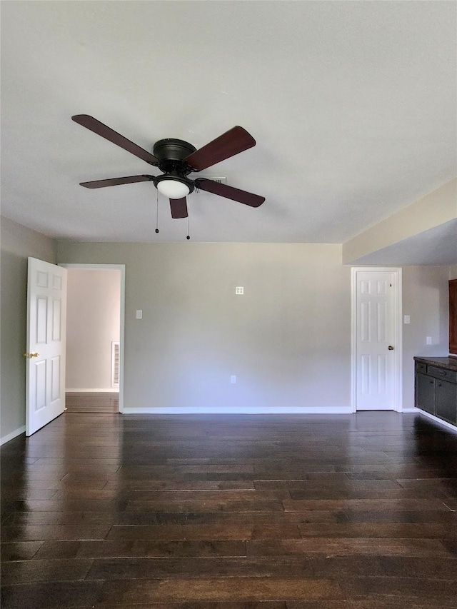 unfurnished living room with dark hardwood / wood-style floors and ceiling fan