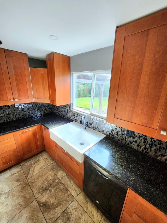 kitchen with backsplash, sink, and dark stone counters