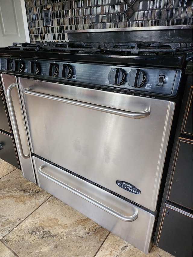 details with stainless steel range and tasteful backsplash