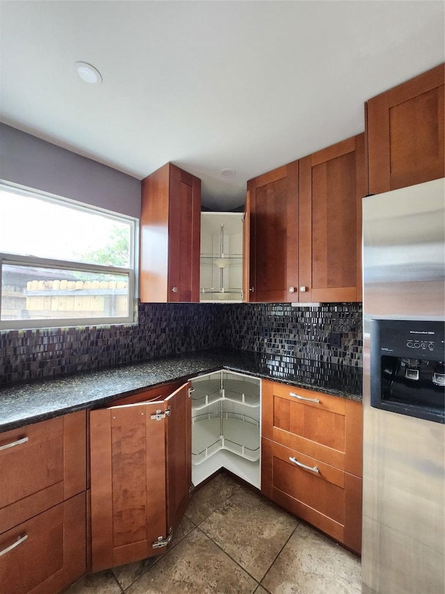 kitchen with decorative backsplash and stainless steel fridge