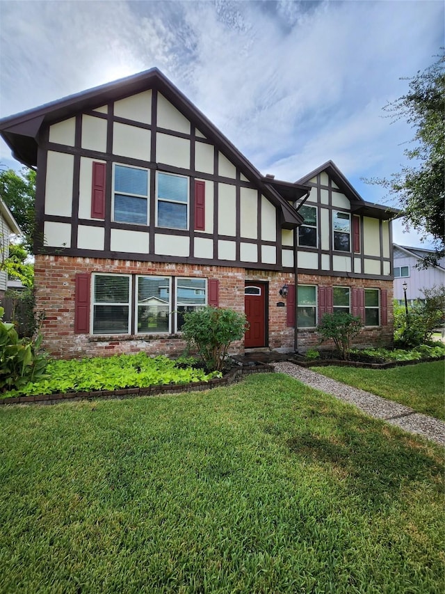 tudor home with a front yard