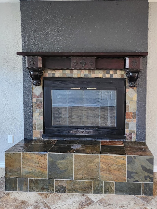 details with a tiled fireplace