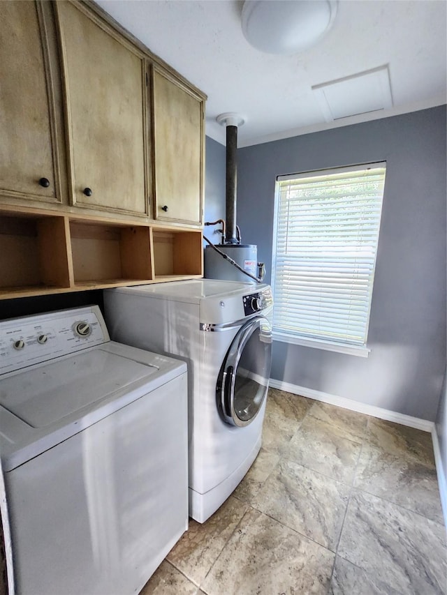 laundry area with cabinets, washer and dryer, and water heater