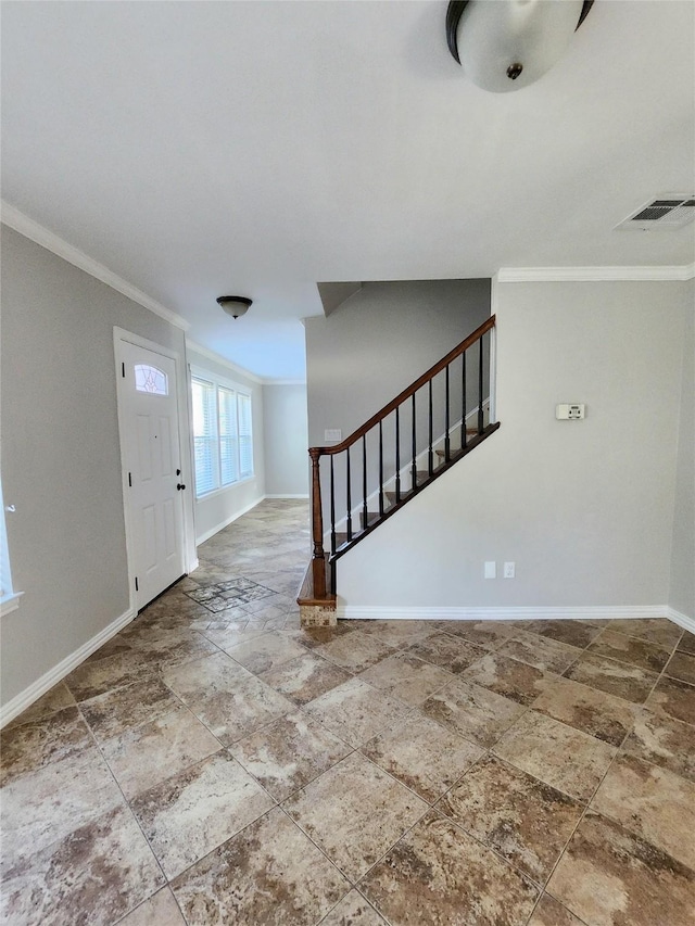 foyer featuring crown molding