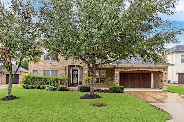 view of front of home with a garage and a front yard