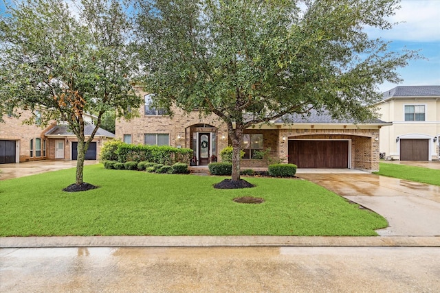 2826 S Cotswold Manor Dr, Kingwood, TX 77339 - view of front facade with brick siding, a front lawn, an attached garage, and driveway