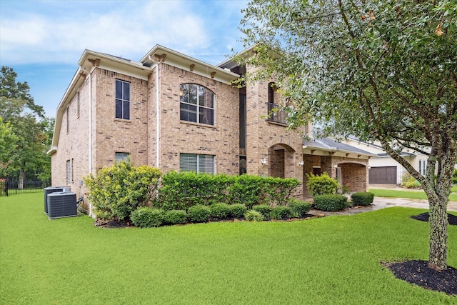 2826 S Cotswold Manor Dr, Kingwood, TX 77339 - view of front of house featuring concrete driveway, cooling unit, a front yard, brick siding, and fence