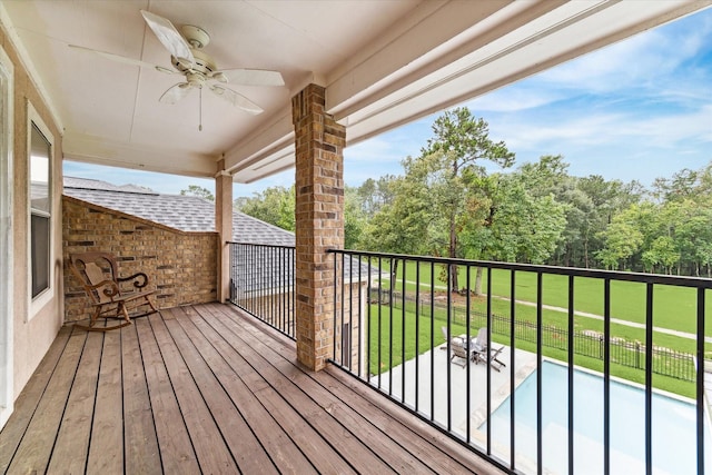 deck featuring a yard and ceiling fan