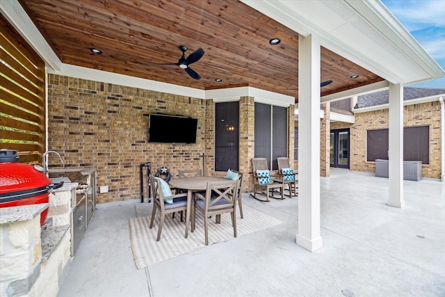 view of patio with ceiling fan and exterior kitchen