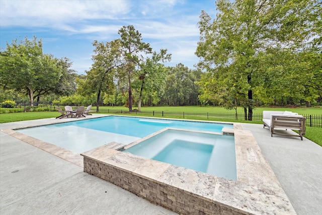 view of pool featuring an in ground hot tub, a patio area, and a lawn