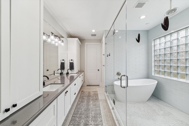 bathroom with tile patterned flooring, vanity, tile walls, and independent shower and bath