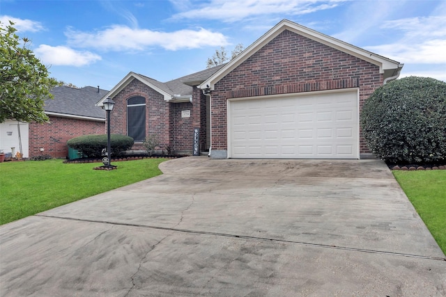 ranch-style house with a garage and a front lawn