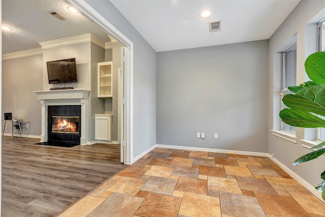 unfurnished living room with a fireplace, light hardwood / wood-style flooring, and ornamental molding