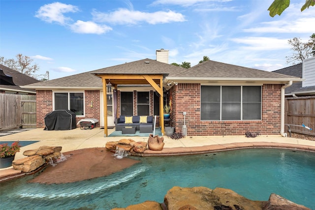 rear view of property featuring outdoor lounge area, a patio, and a fenced in pool