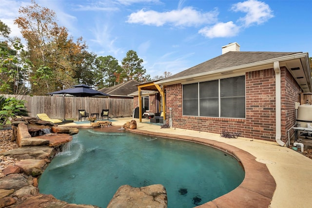 view of pool featuring pool water feature and a patio