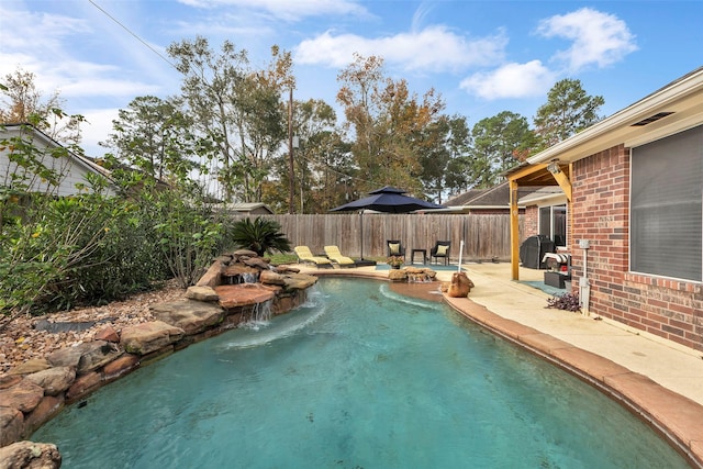 view of pool with pool water feature and a patio area