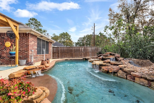 view of swimming pool with pool water feature