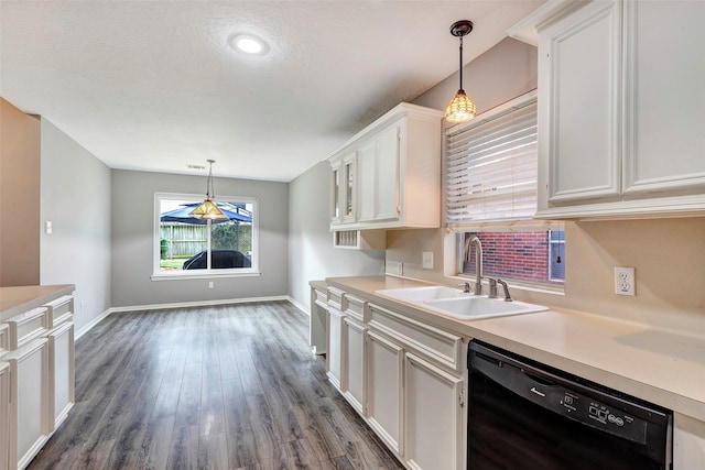 kitchen with sink, black dishwasher, dark hardwood / wood-style flooring, decorative light fixtures, and white cabinets