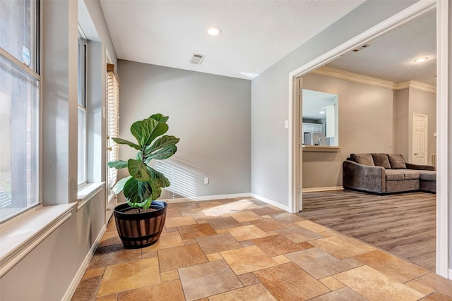 hall featuring ornamental molding and light hardwood / wood-style flooring