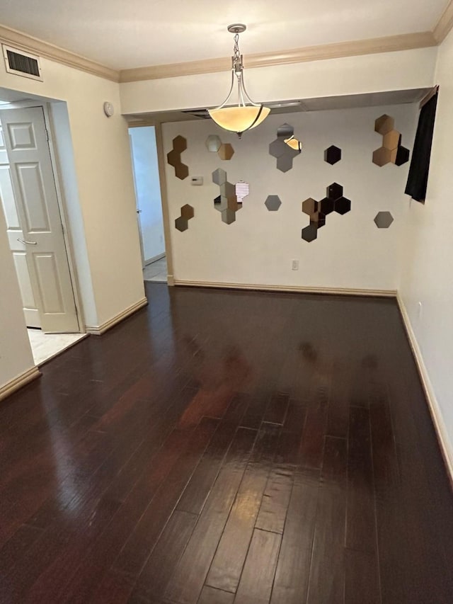 unfurnished dining area featuring dark hardwood / wood-style floors and ornamental molding