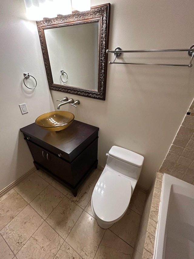 bathroom with a bathing tub, vanity, and toilet