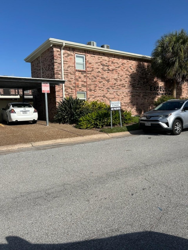 view of side of property with a carport