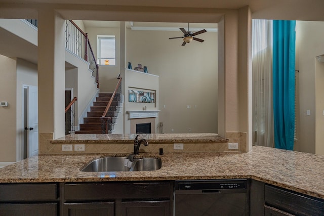 kitchen with dishwasher, ceiling fan, dark brown cabinetry, and sink