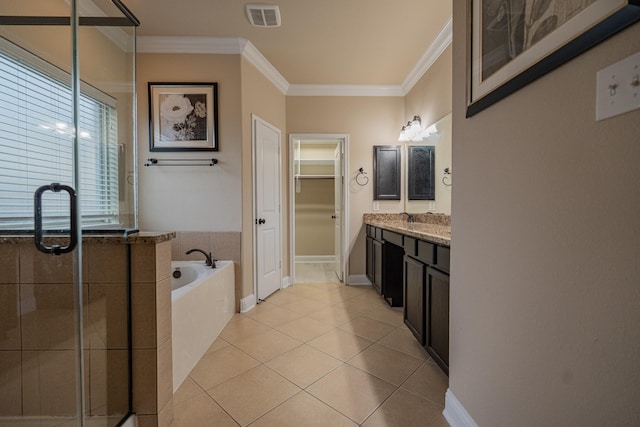 bathroom featuring tile patterned floors, vanity, ornamental molding, and shower with separate bathtub