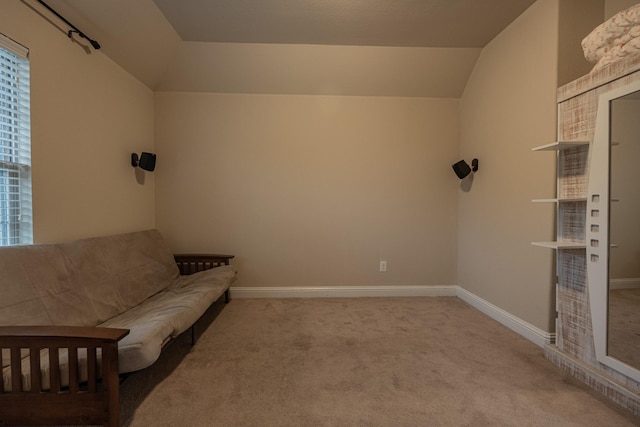 sitting room featuring light carpet and lofted ceiling