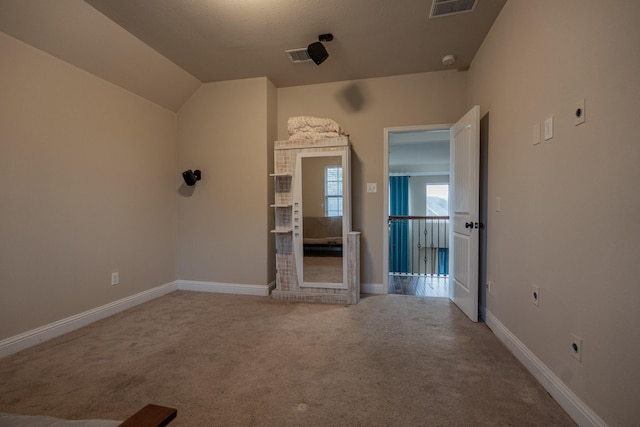 interior space featuring carpet and vaulted ceiling