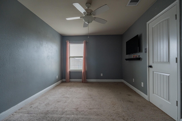 unfurnished room featuring light carpet and ceiling fan