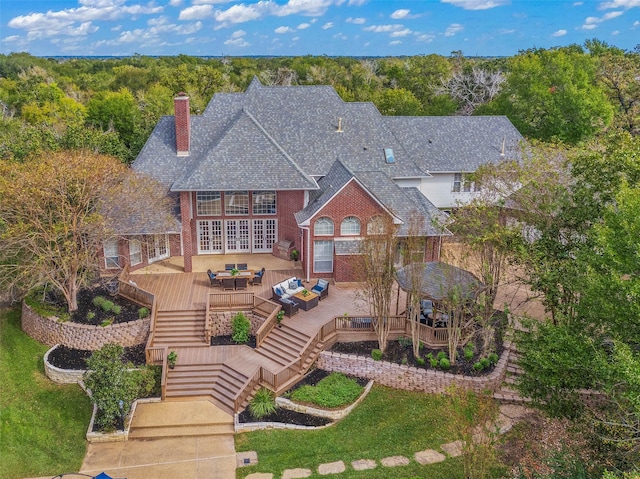 back of property featuring a yard and an outdoor hangout area