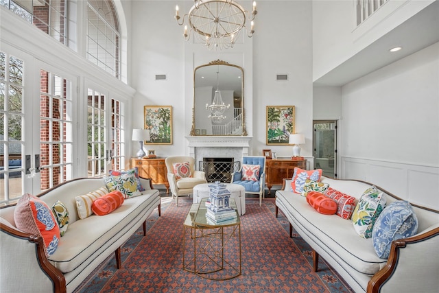 living room with a towering ceiling and an inviting chandelier