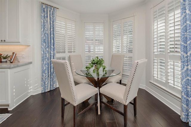 dining space with dark wood-type flooring and a wealth of natural light