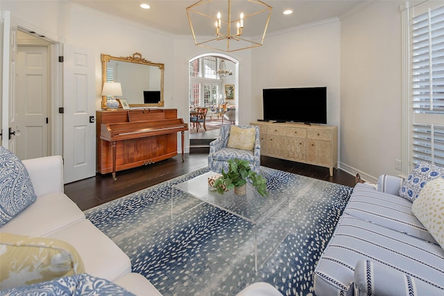 living room with french doors, dark hardwood / wood-style floors, an inviting chandelier, and ornamental molding