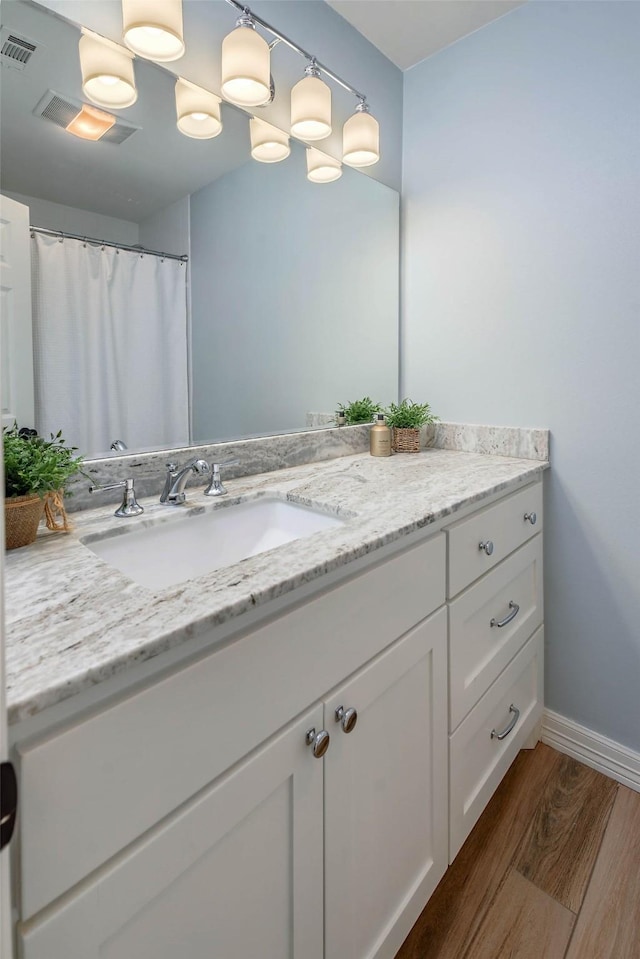 bathroom featuring hardwood / wood-style flooring and vanity