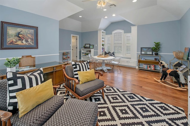 living room with wood-type flooring, ceiling fan, and lofted ceiling