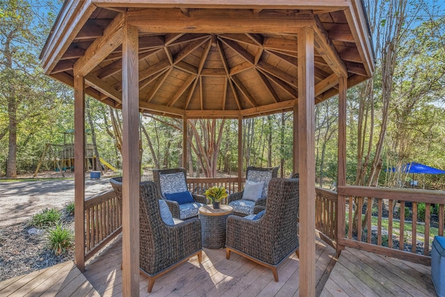 wooden terrace with a playground and a gazebo