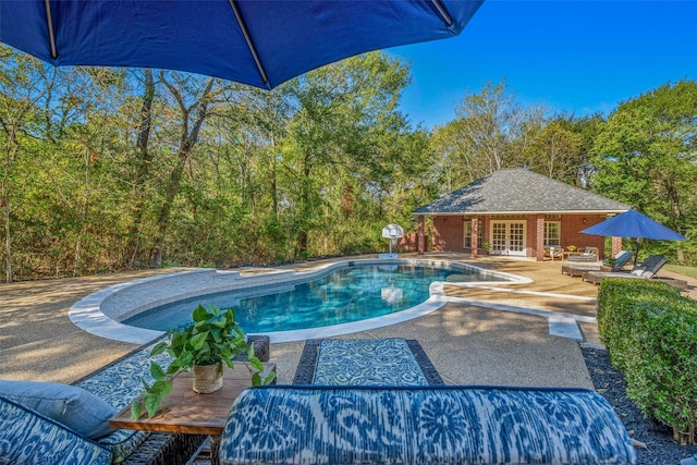 view of swimming pool with an outdoor structure and a patio