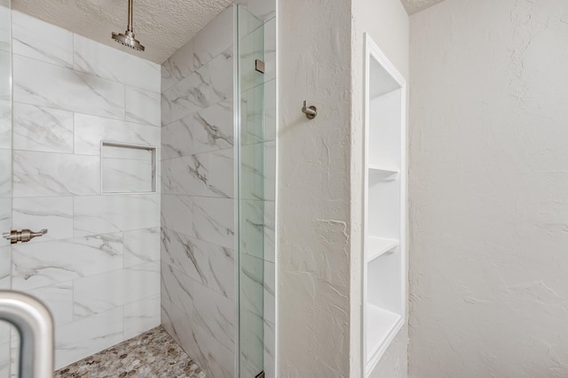 bathroom with a textured ceiling and walk in shower