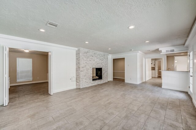 unfurnished living room with a textured ceiling and a fireplace