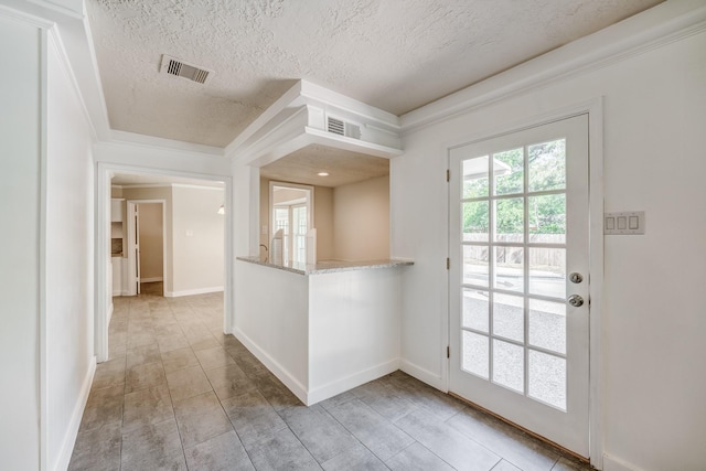 entryway featuring a textured ceiling