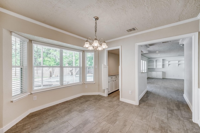 unfurnished dining area with plenty of natural light, a textured ceiling, and an inviting chandelier