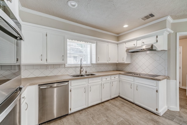 kitchen with a textured ceiling, stainless steel appliances, white cabinetry, and sink