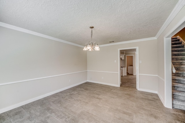 spare room with crown molding, a textured ceiling, and a chandelier