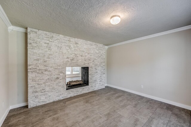 unfurnished living room with a fireplace, crown molding, and a textured ceiling