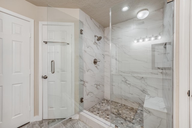 bathroom featuring a textured ceiling and an enclosed shower