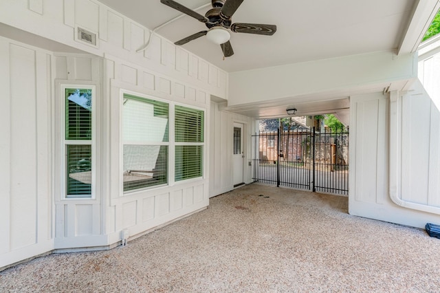 unfurnished sunroom featuring ceiling fan