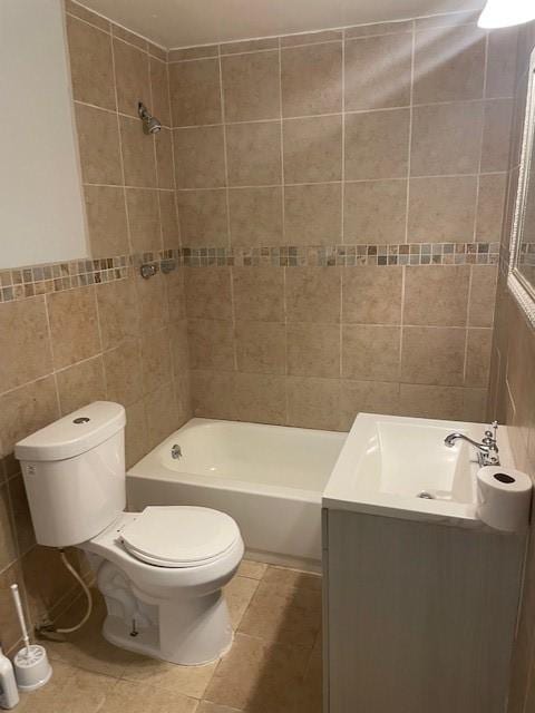 full bathroom featuring tile patterned flooring, vanity, tile walls, and toilet